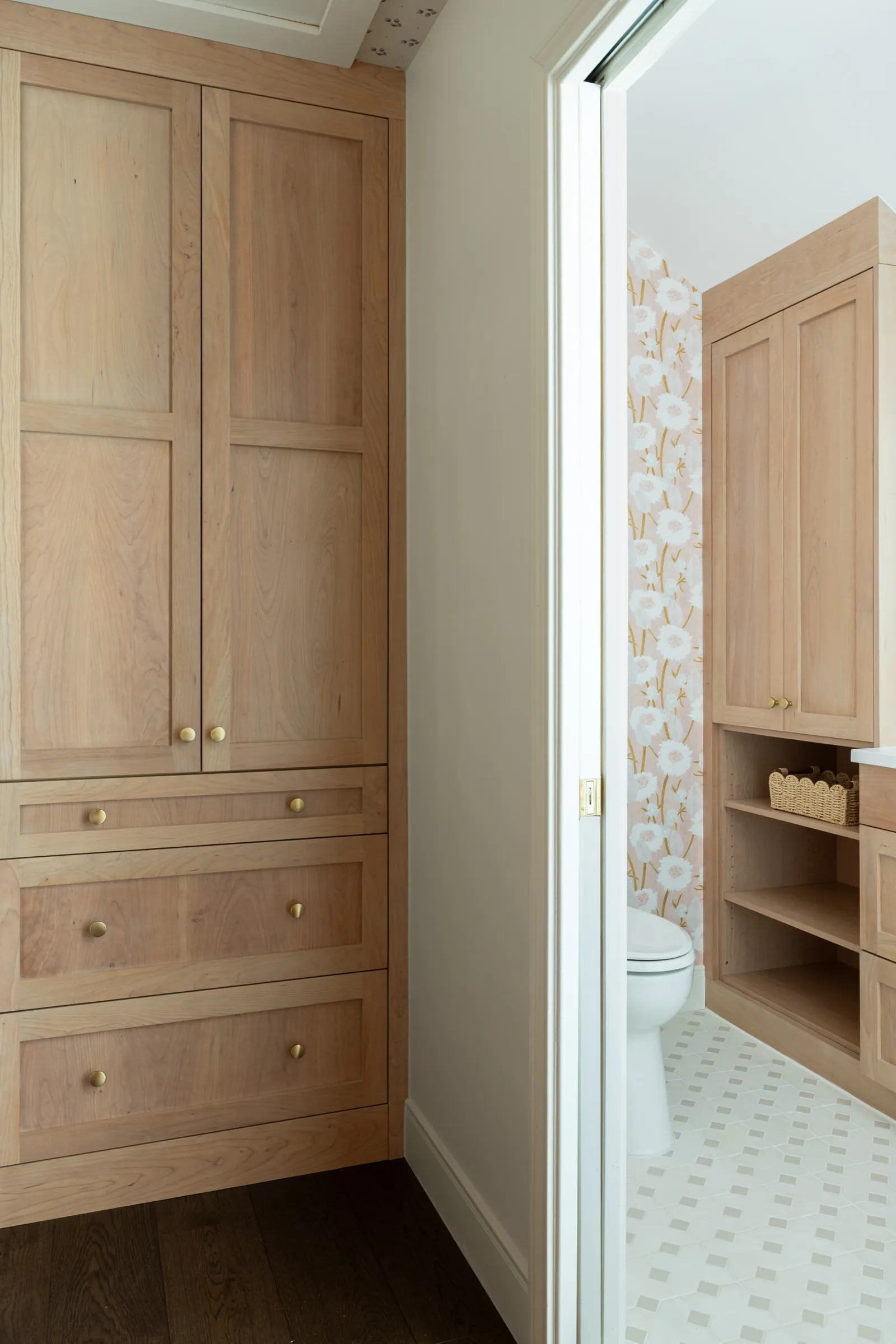 White oak linen cabinet on the landing, the papered bathroom through the open door